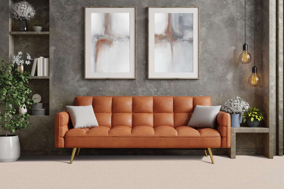 beige patterned area rug in retro style living room with leather couch and gray washed accent wall